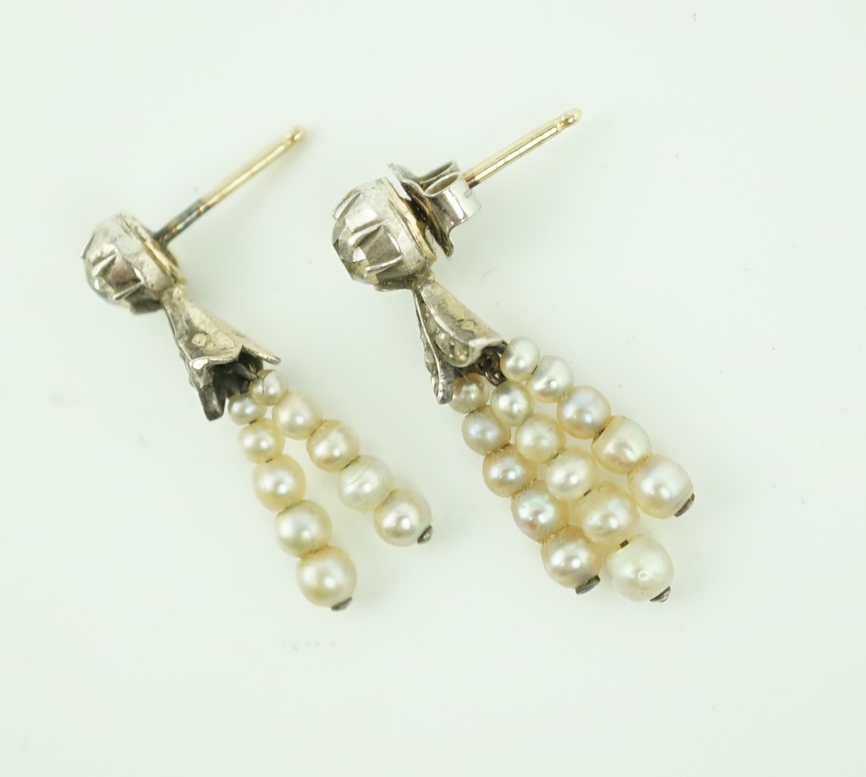 A pair of antique gold, graduated seed pearl, cushion and rose cut diamond set tassel drop earrings